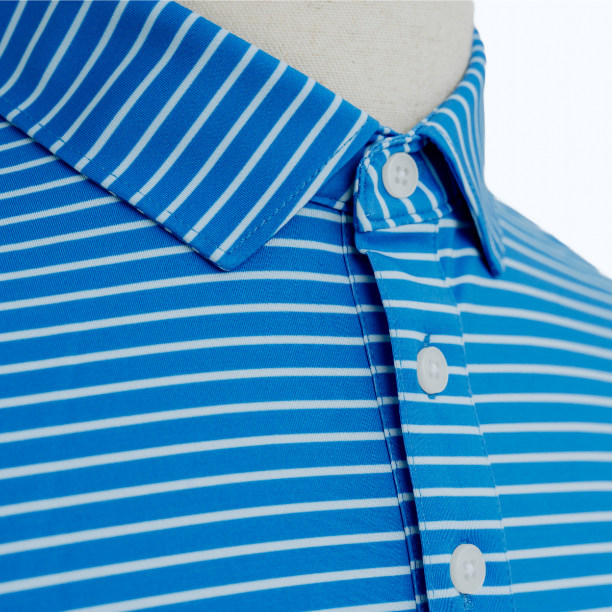 Close-up product detail of the Palmetto Clothing The Anderson Polo in French Blue showcasing the premium fabric, signature stripe design, refined stitching, and craftsmanship that define our best golf polos.