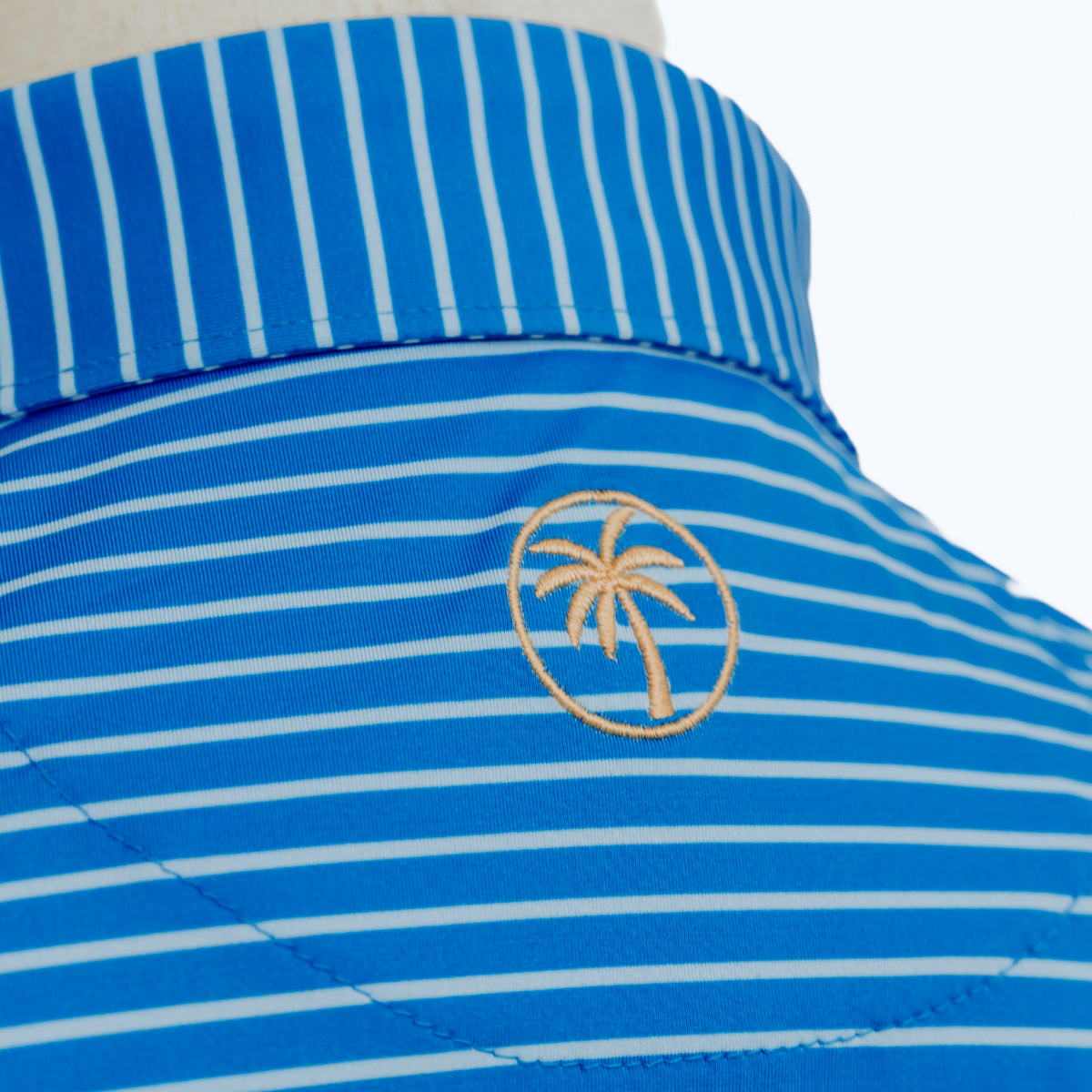 Close-up product detail of the Palmetto Clothing The Anderson Polo in French Blue showcasing the premium fabric, signature stripe design, refined stitching, and craftsmanship that define our best golf polos.