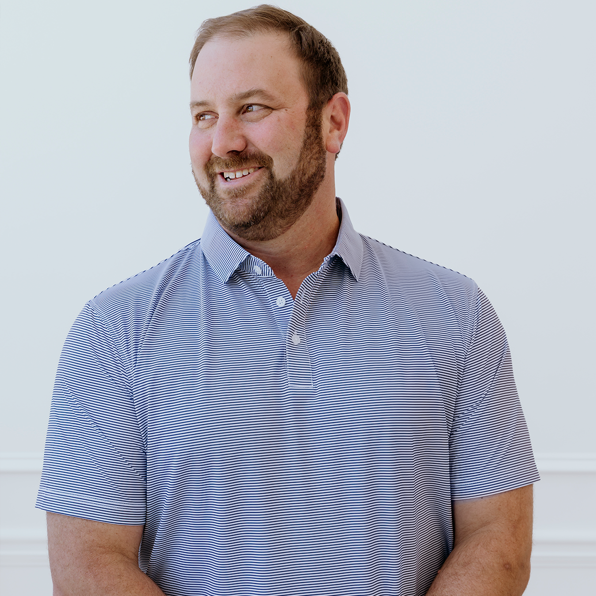 Front view of the Palmetto Clothing The Classic Stripe Polo in Navy Blue showcasing classic white and navy stripes. A performance golf polo shirt designed for breathable comfort and everyday versatility.