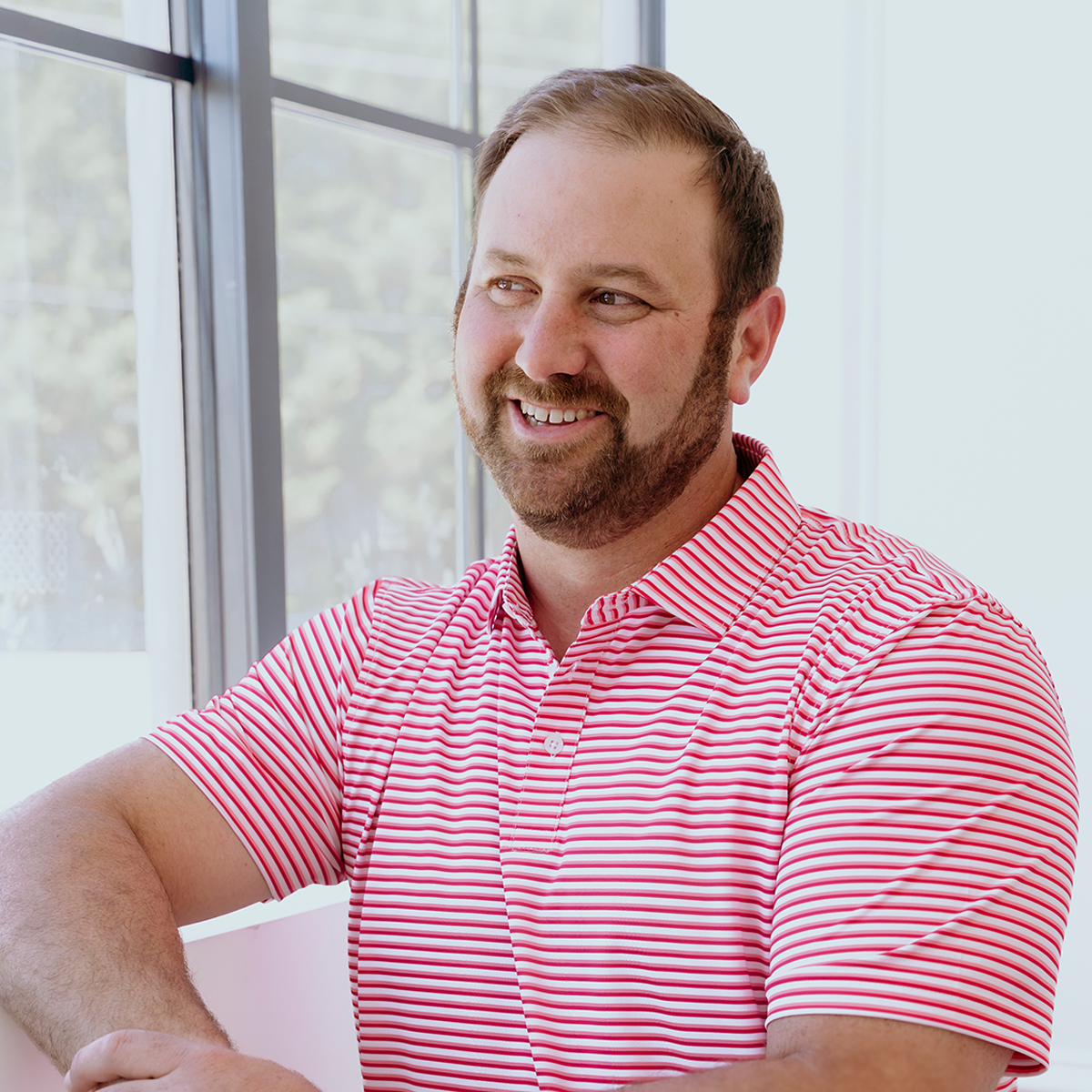 Model wearing the Palmetto Clothing The Double Double Polo in Pink featuring our signature double stripe design. One of our premium performance golf shirts combining lightweight comfort with modern style on and off the course.