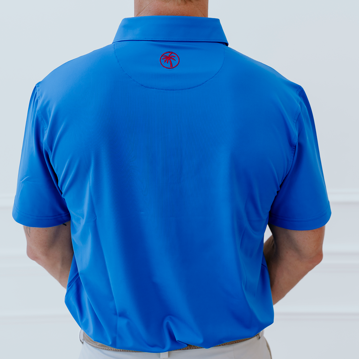 Back view of the Palmetto Clothing The Wayne Polo in Royal Blue highlighting the lightweight performance fabric and athletic fit of this premium golf polo.