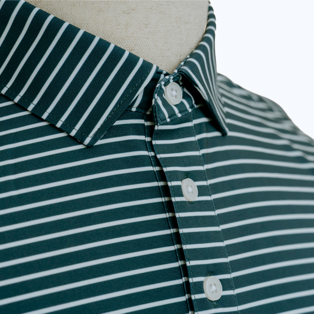 Close-up detail of the Palmetto Clothing The Anderson Polo in Aquamarine showcasing the premium fabric, signature stripe pattern, refined stitching, and craftsmanship behind our golf polo shirts.