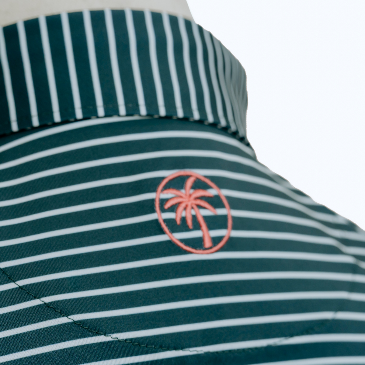 Close-up detail of the Palmetto Clothing The Anderson Polo in Aquamarine showcasing the premium fabric, signature stripe pattern, refined stitching, and craftsmanship behind our golf polo shirts.