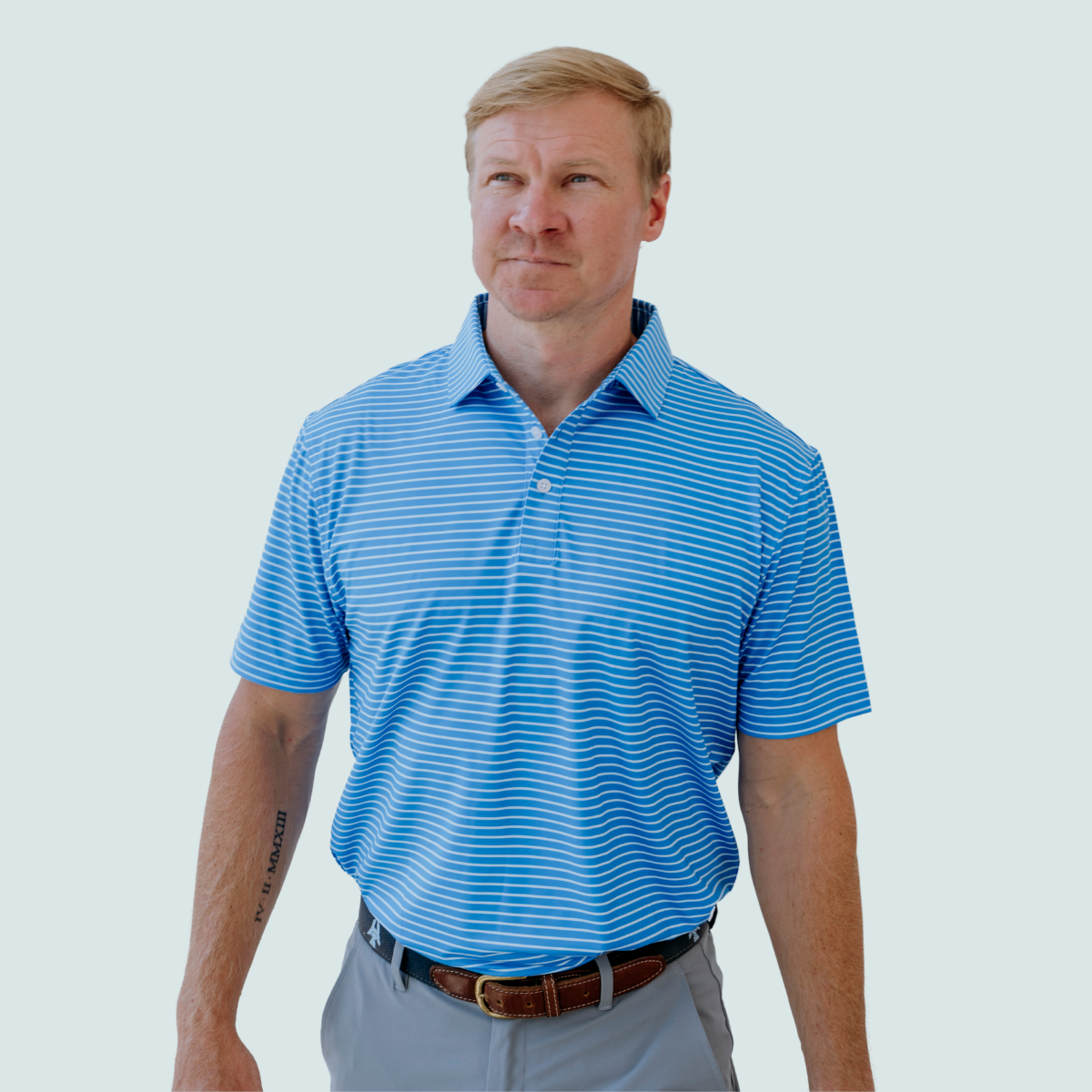 Model wearing the Palmetto Clothing The Anderson Polo in French Blue featuring our signature stripe design. One of our best golf polos, combining premium comfort, lightweight performance fabric, and timeless style.