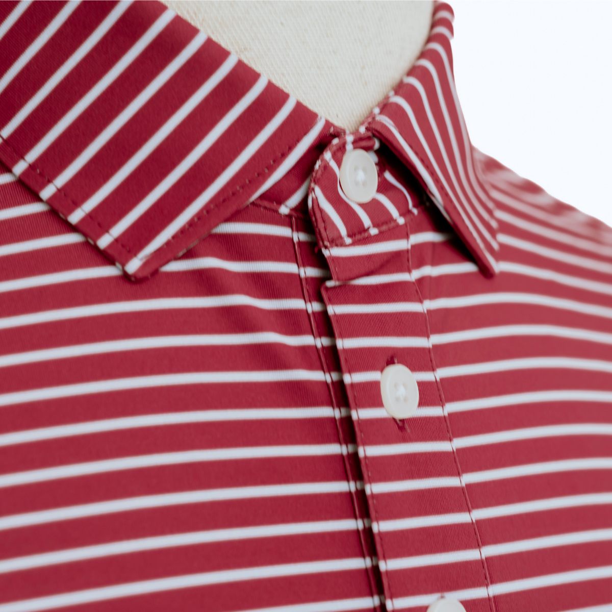 Close-up product detail of the Palmetto Clothing The Anderson Polo in Persian Red featuring the premium fabric, signature stripe design, refined stitching, and craftsmanship found in our breathable golf polo shirts.