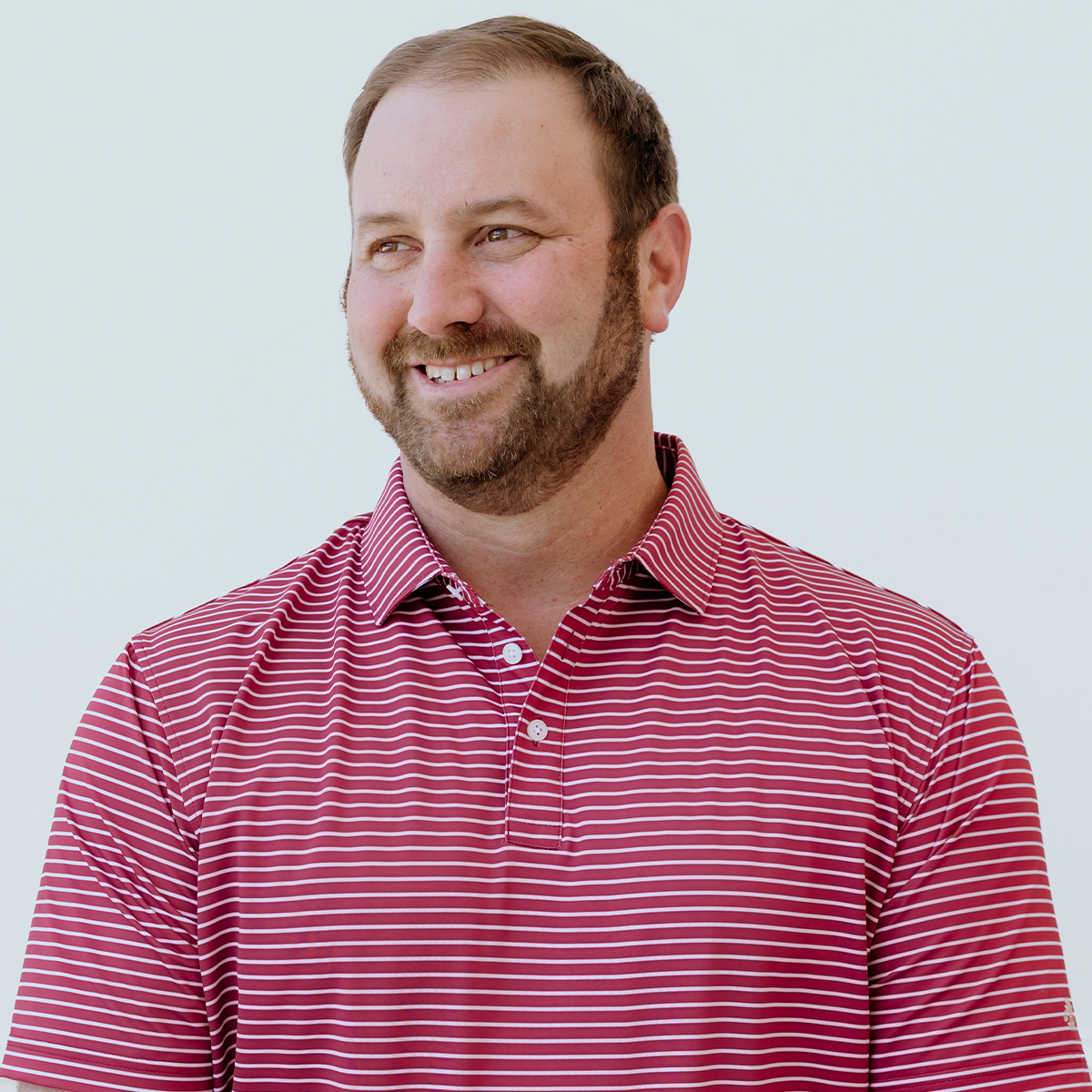 Front view of the Palmetto Clothing The Anderson Polo in Persian Red showcasing the modern stripe pattern and premium construction. One of our best golf shirts designed for timeless style and everyday performance.
