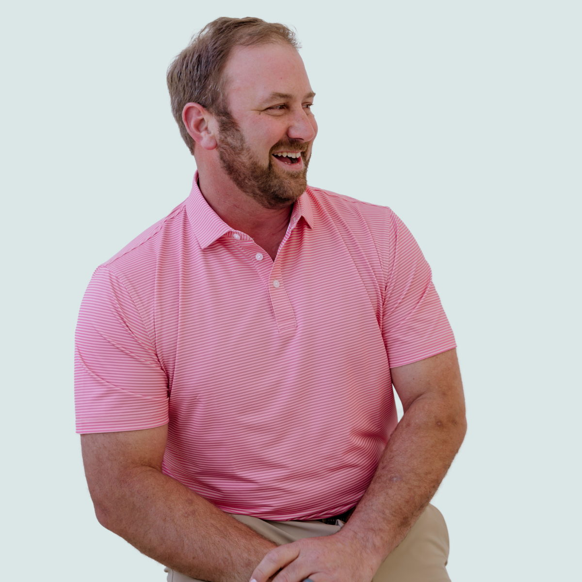 Front view of the Palmetto Clothing The Classic Stripe Polo in Peach featuring a classic striped design with lightweight performance fabric and timeless style for golfers.