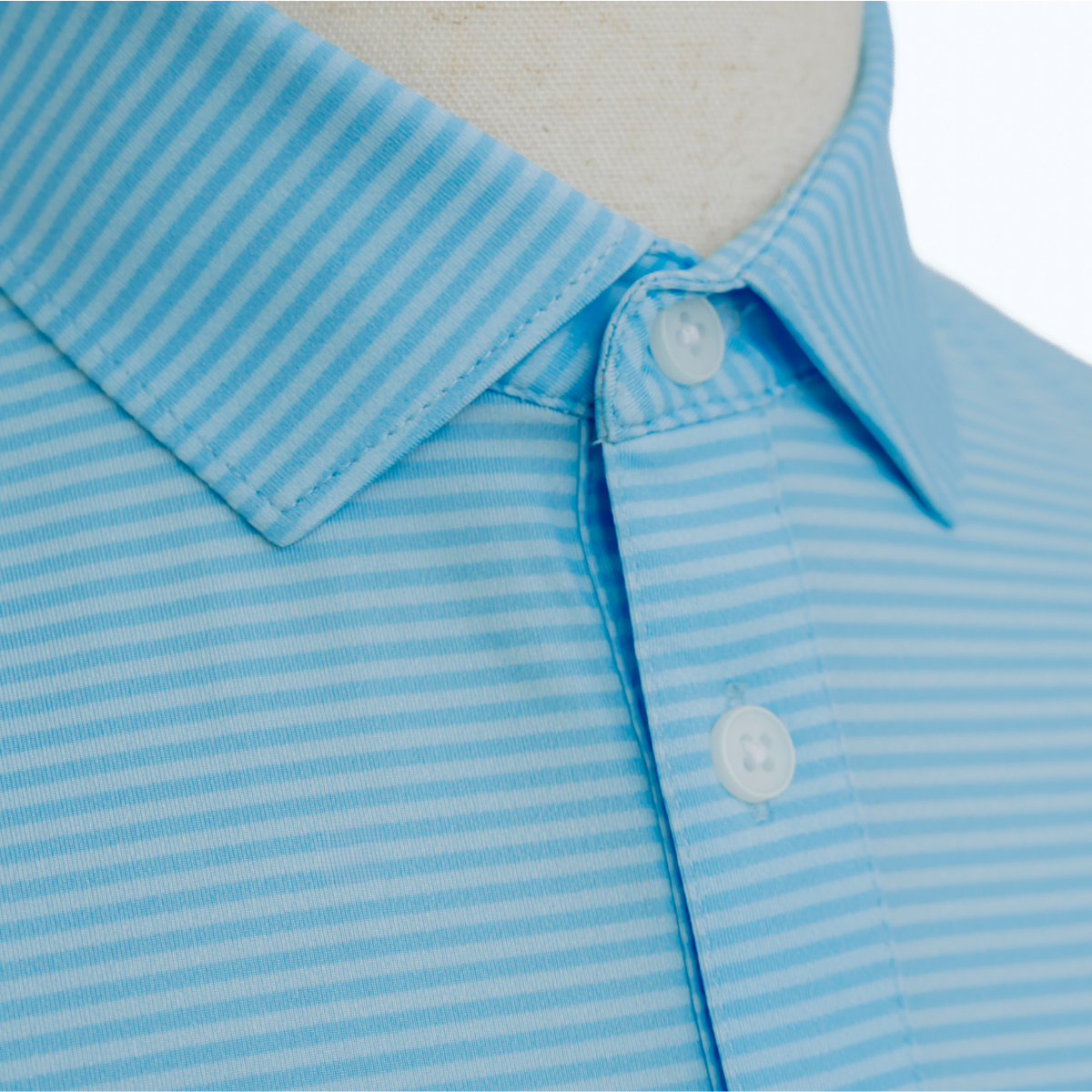 Close-up detail of the Palmetto Clothing The Classic Stripe Polo in Sky Blue showcasing the premium fabric, soft texture, and craftsmanship behind one of our favorite performance golf polos.