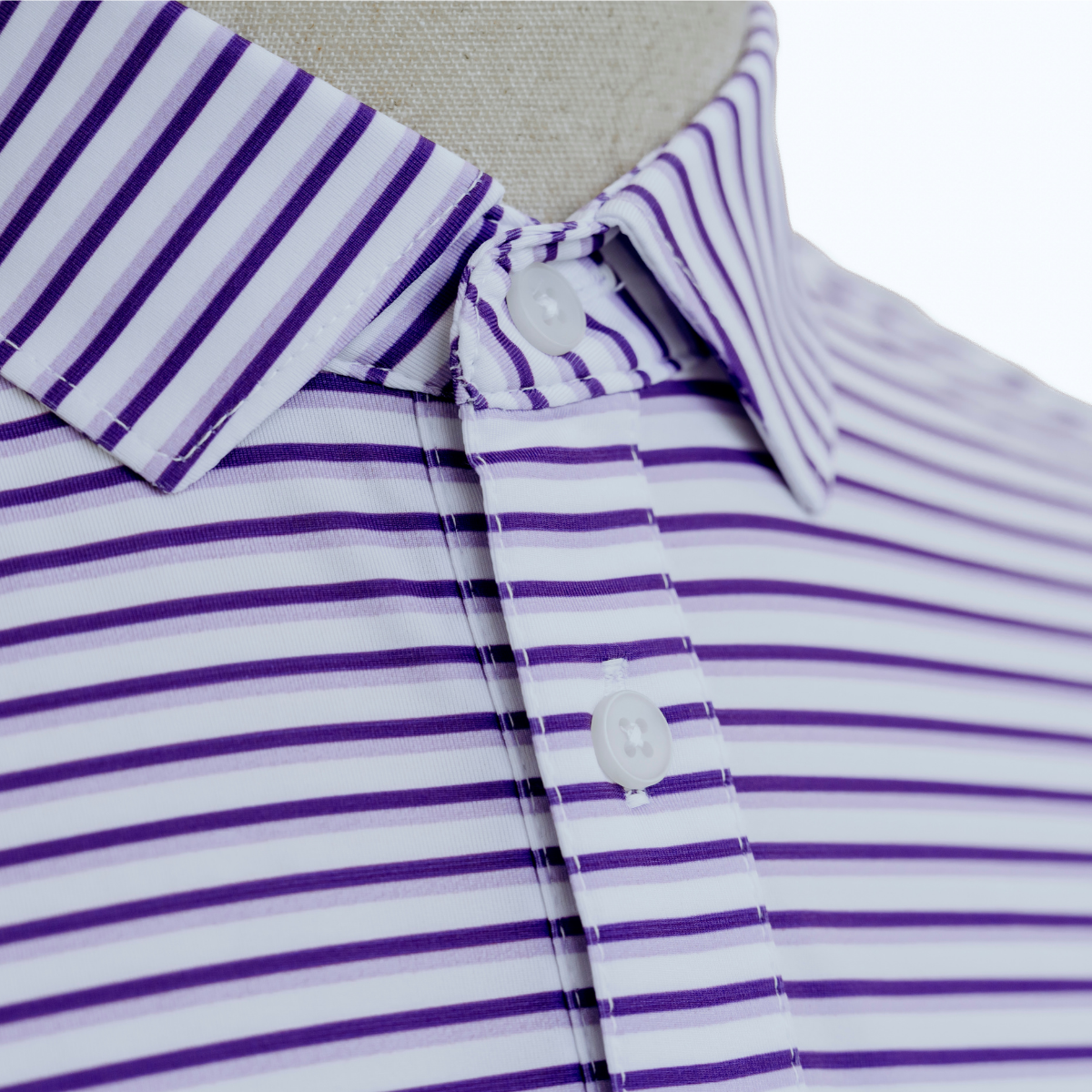 Close-up product detail of the Palmetto Clothing The Double Double Polo in Purple showcasing the premium fabric, signature double stripe pattern, refined stitching, and craftsmanship behind our performance golf polos.