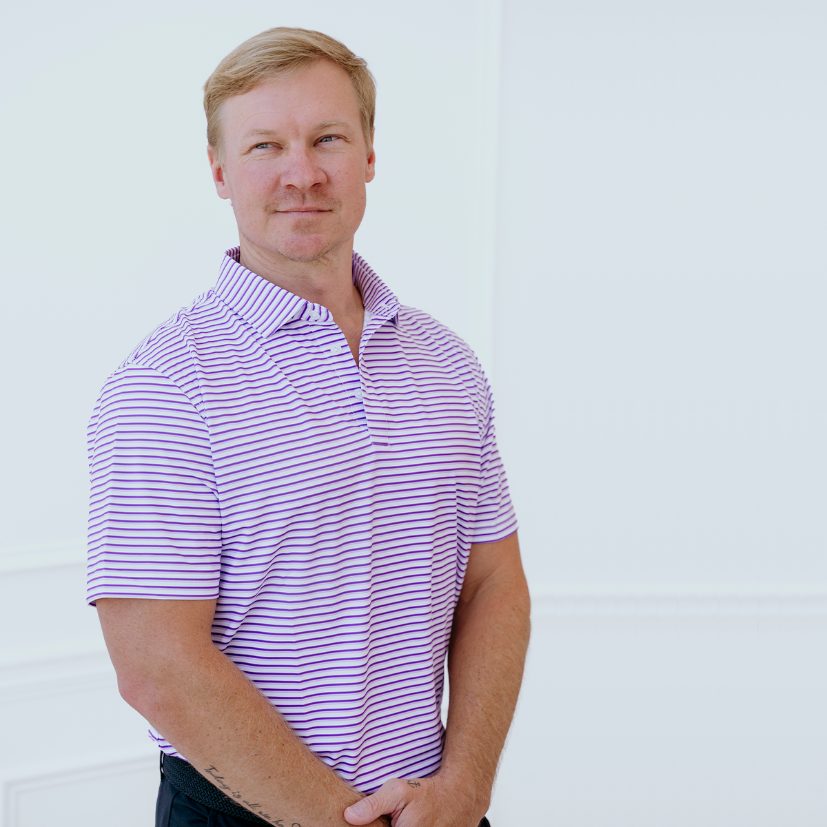 Model wearing the Palmetto Clothing The Double Double Polo in Purple featuring our signature double stripe design. One of our premium golf shirts for men, crafted with lightweight performance fabric and exceptional comfort for every round.