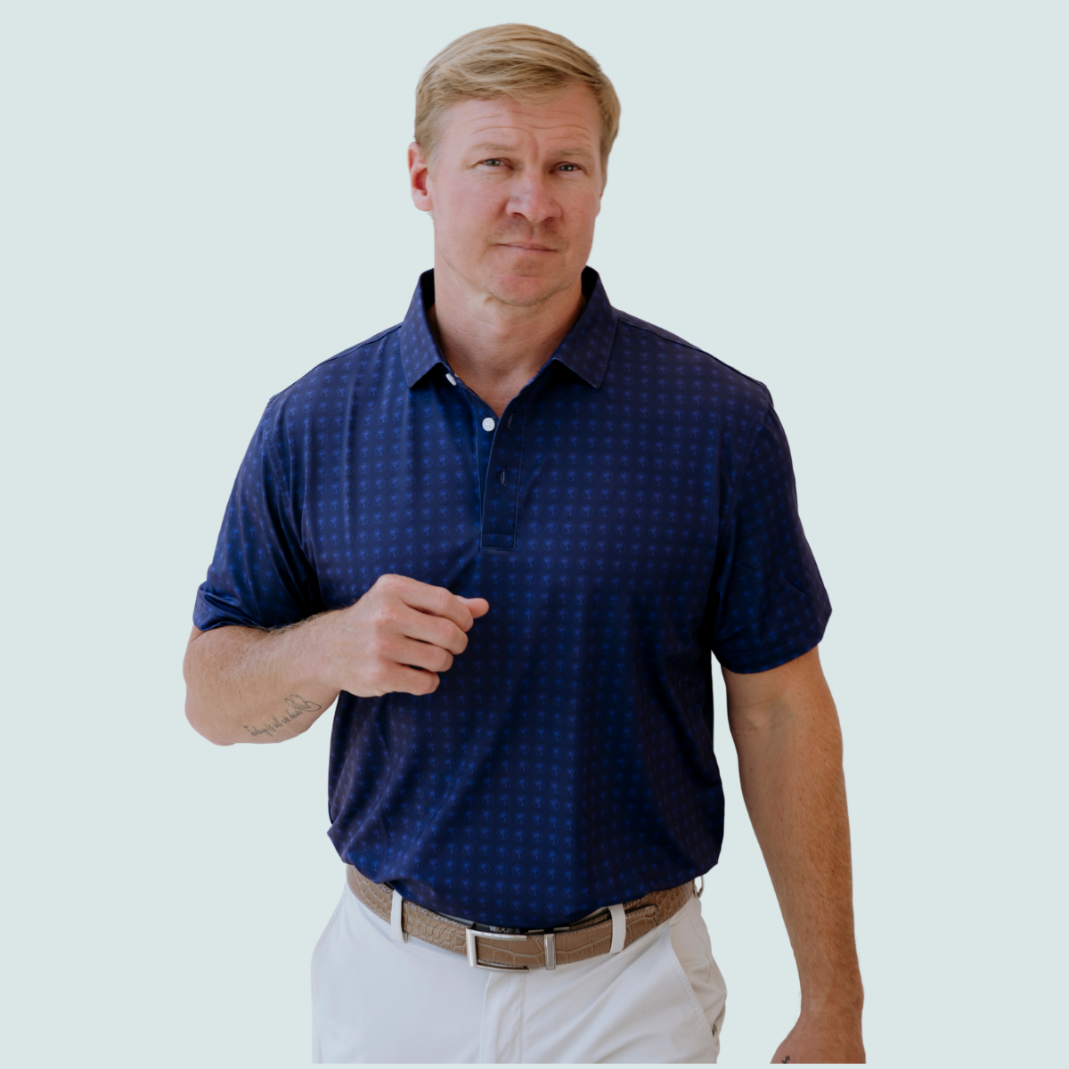 Front view of the Palmetto Clothing The Icon Polo in Navy and Blue showcasing the repeating Palmetto logo pattern. One of our best golf polos crafted with lightweight performance fabric and timeless design.