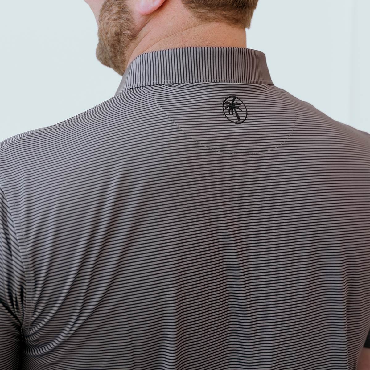 Back view of the Palmetto Clothing The Micro Polo highlighting the athletic fit, lightweight construction, and breathable performance fabric that make this a versatile choice for golf, the office, and everyday life.