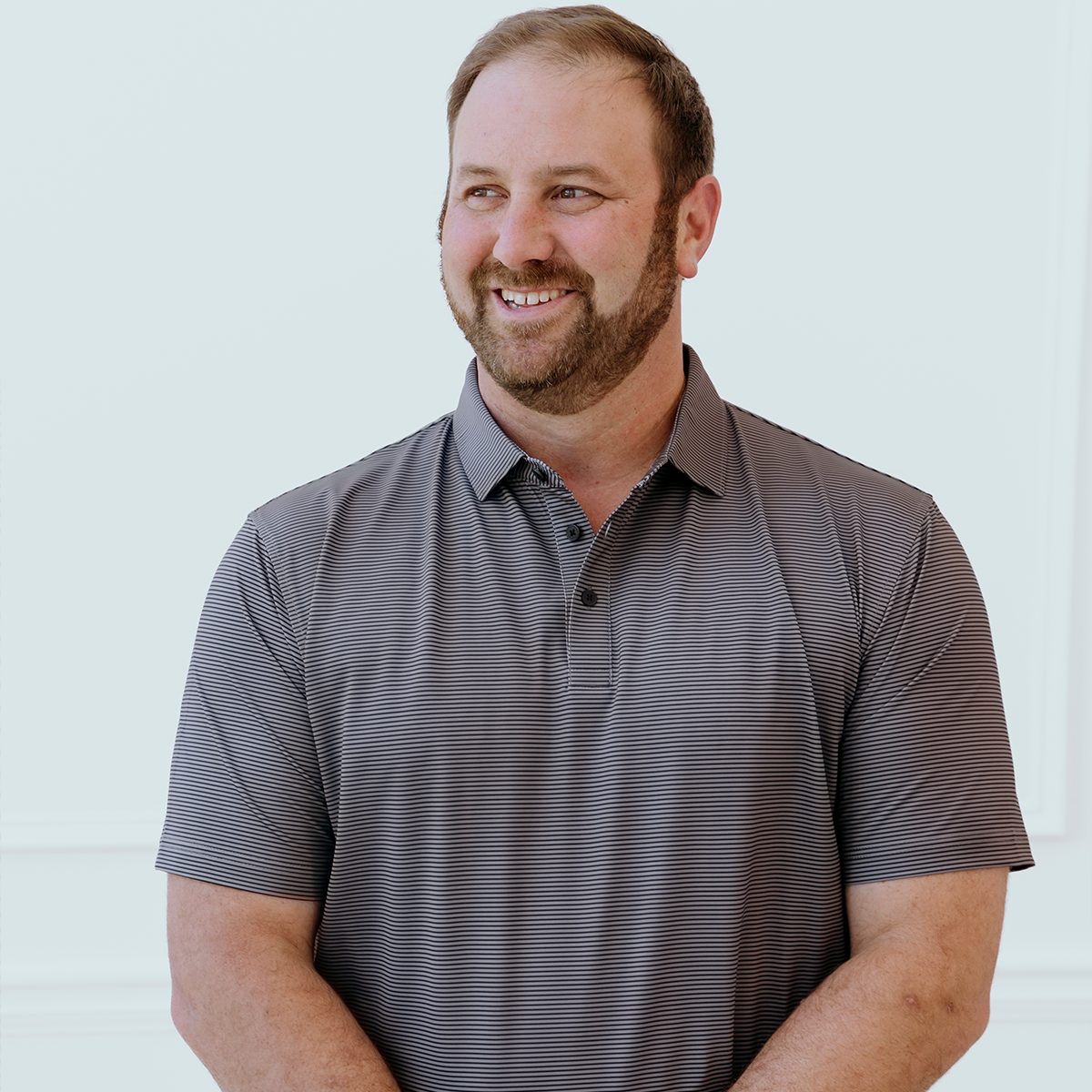 Model wearing the Palmetto Clothing The Micro Polo featuring subtle repeating micro stripes in contrasting colors. A premium lightweight golf polo for men designed with breathable performance fabric, exceptional comfort, and timeless style for golfers on and off the course.