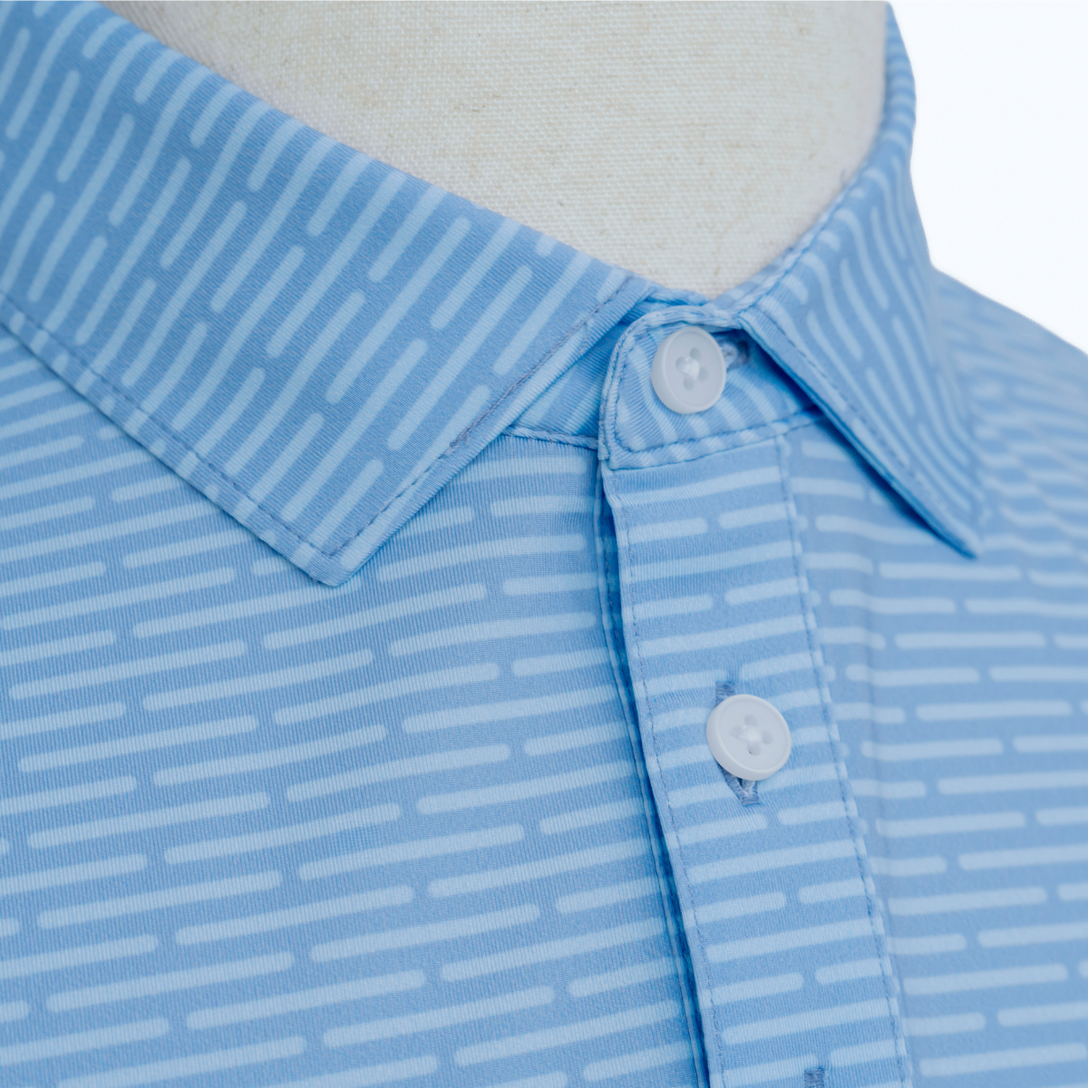 Close-up product detail of the Palmetto Clothing The Pin Dash Polo showcasing the premium fabric, subtle gray pin dash stripe pattern, refined stitching, and craftsmanship behind one of our favorite patterned golf polos.