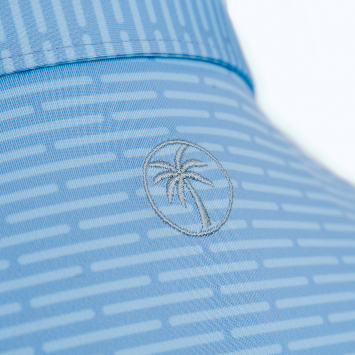 Close-up product detail of the Palmetto Clothing The Pin Dash Polo showcasing the premium fabric, subtle gray pin dash stripe pattern, refined stitching, and craftsmanship behind one of our favorite patterned golf polos.