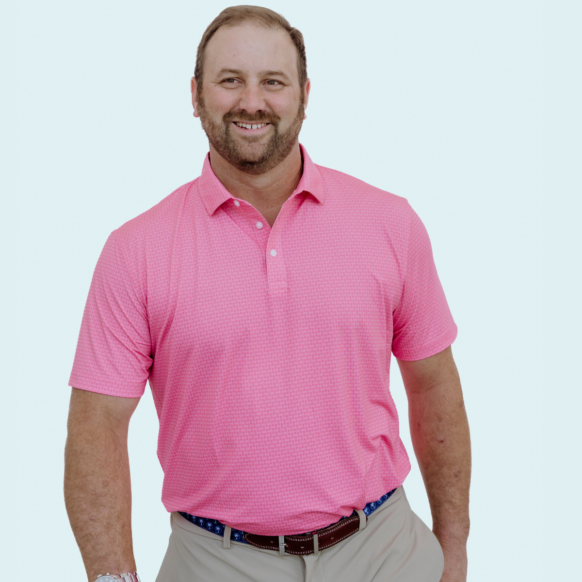 Front view of the Palmetto Clothing The Shots Polo showcasing the playful repeating shot glass pattern across a vibrant pink polo. A premium patterned golf polo designed with breathable performance fabric and timeless comfort.
