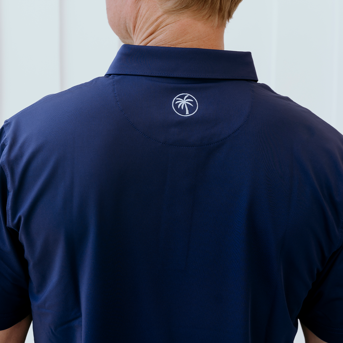 Back view of the Palmetto Clothing The Wayne Polo in Navy highlighting its modern fit, breathable construction, and premium comfort for golf and everyday wear.