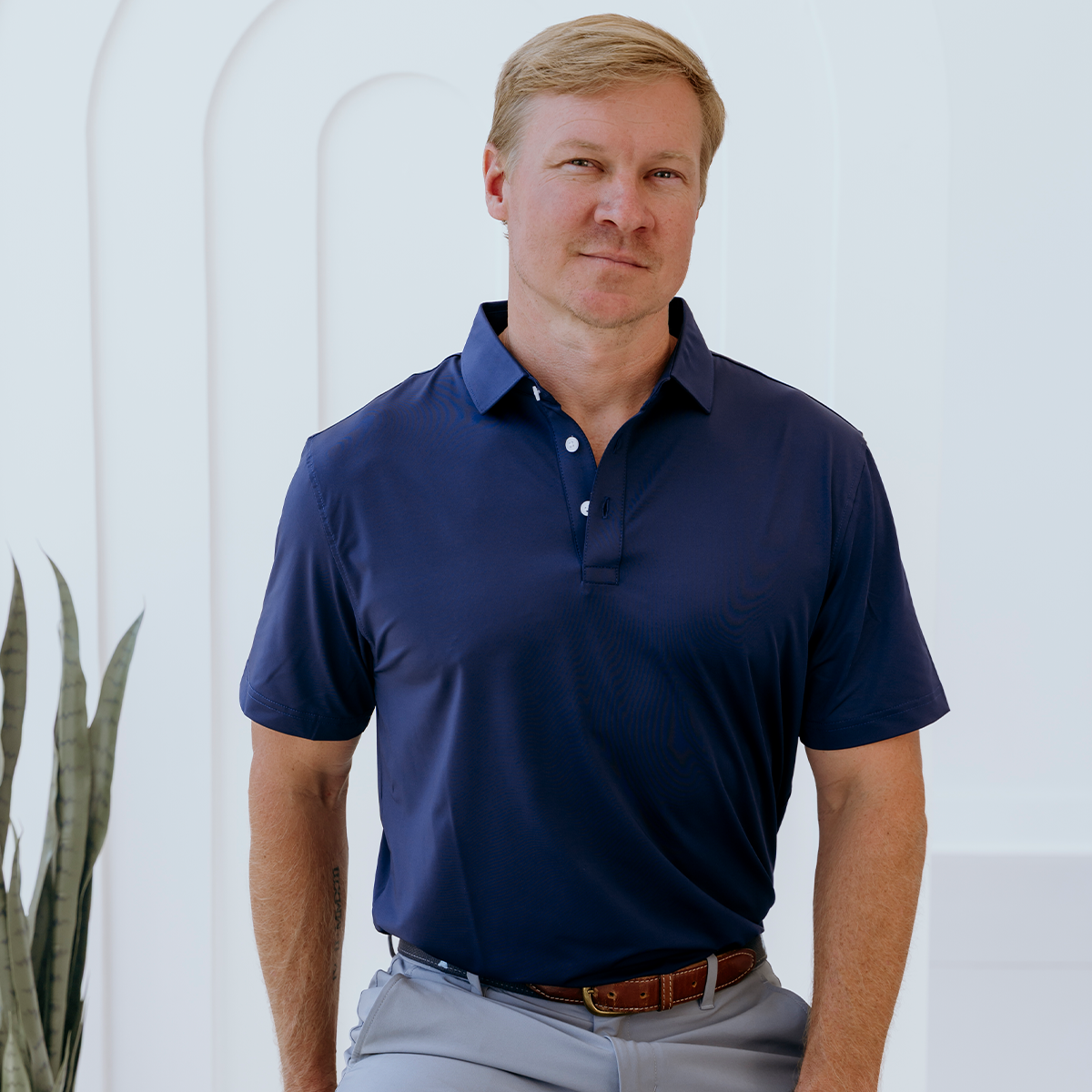 Front view of the Palmetto Clothing The Wayne Polo in Navy featuring a classic solid design. This navy golf shirt is crafted from premium performance fabric with exceptional softness and four-way stretch.