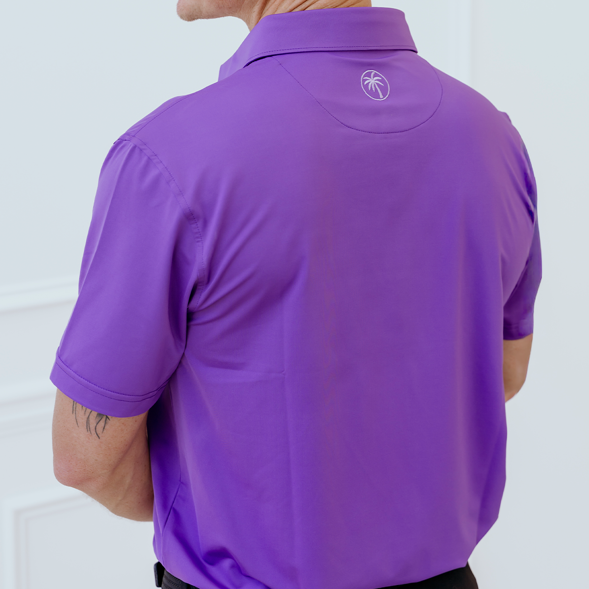 Back view of the Palmetto Clothing The Wayne Polo in Purple highlighting its breathable fabric, modern fit, and exceptional comfort for golfers.