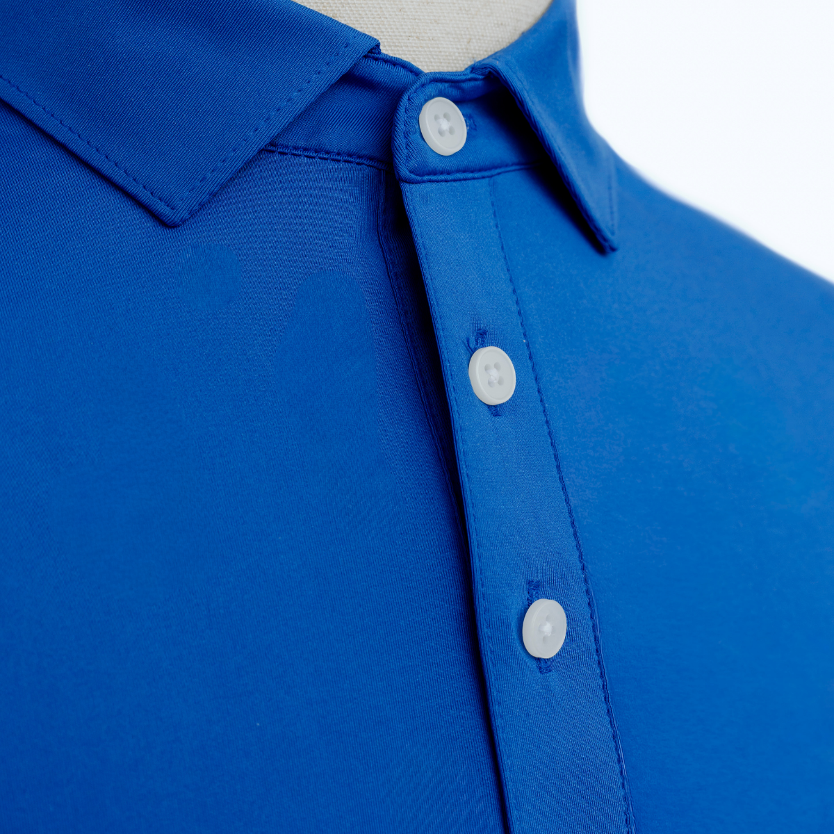 Close-up product image of the Palmetto Clothing The Wayne Polo in Royal Blue showcasing the soft performance fabric, refined stitching, and premium finish expected from quality golf polos.