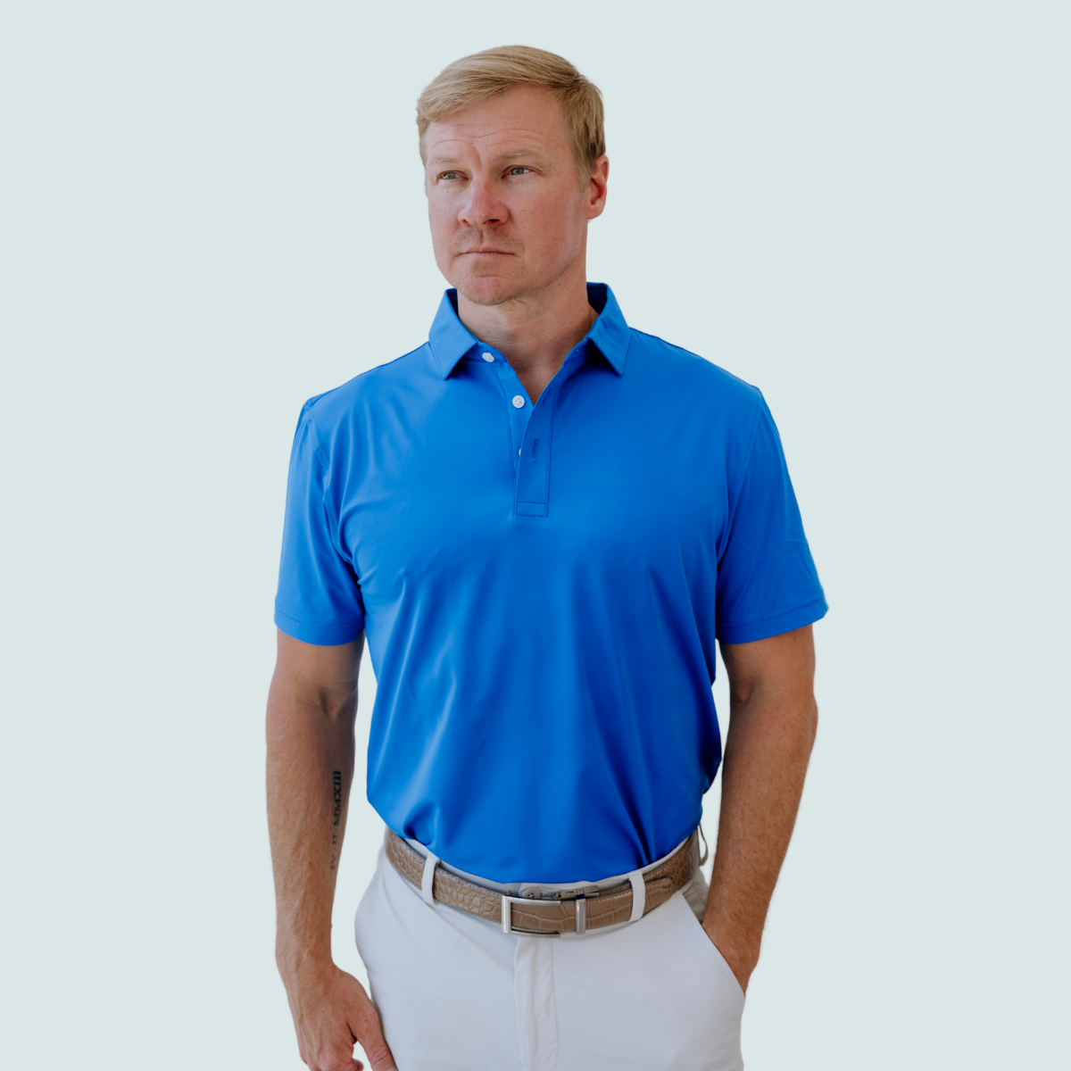 Model wearing the Palmetto Clothing The Wayne Polo in Royal Blue, one of our premium blue golf polo shirt designs combining breathable performance with timeless style for golfers everywhere.